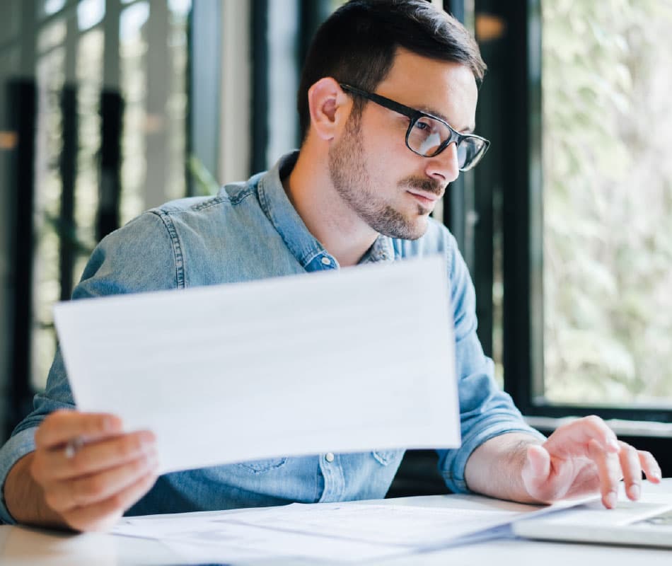 mężczyzna siedzący z dokumentami